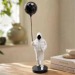 Hooded Figure with Balloon Sculpture