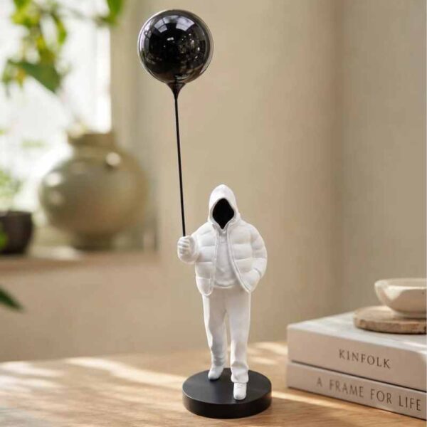 Hooded Figure with Balloon Sculpture